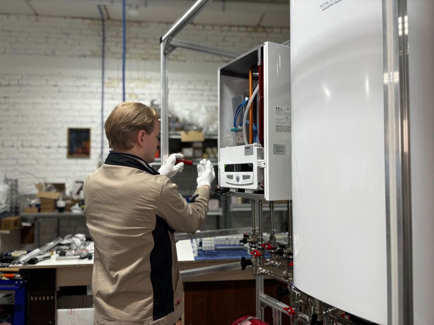 Technician performing maintenance on a heating system