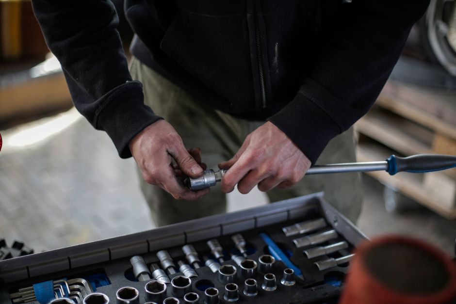 HVAC technician selecting tools from a toolbox